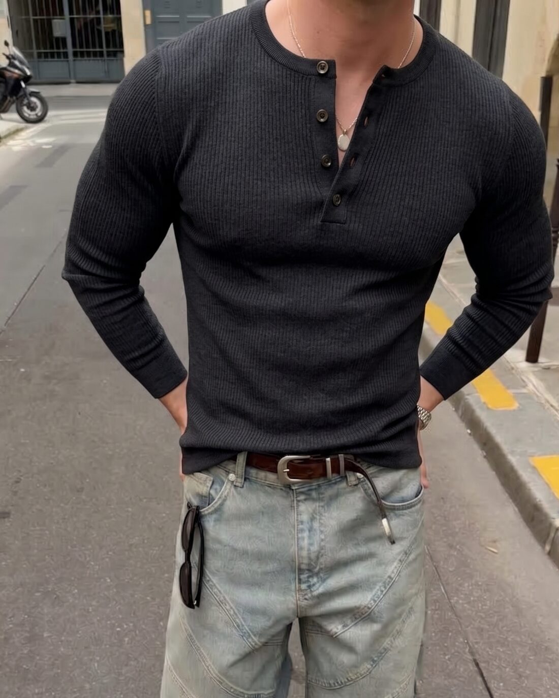 Charcoal ribbed henley worn open at the collar with washed denim